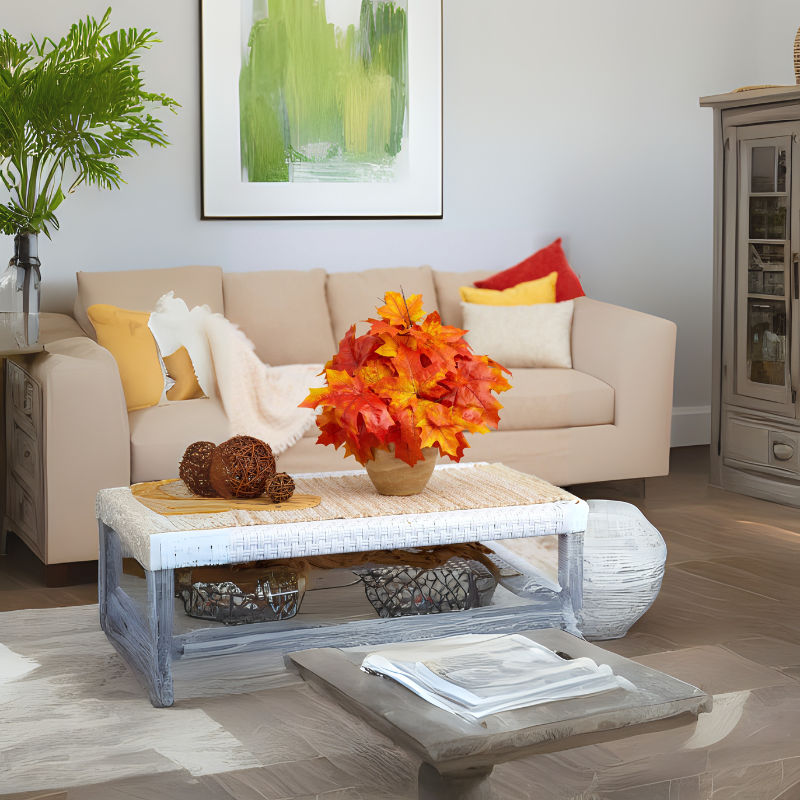Warm-toned living room with neutral sofa, vibrant autumn centerpiece, and cozy decorative accents – styled by Milli Arts