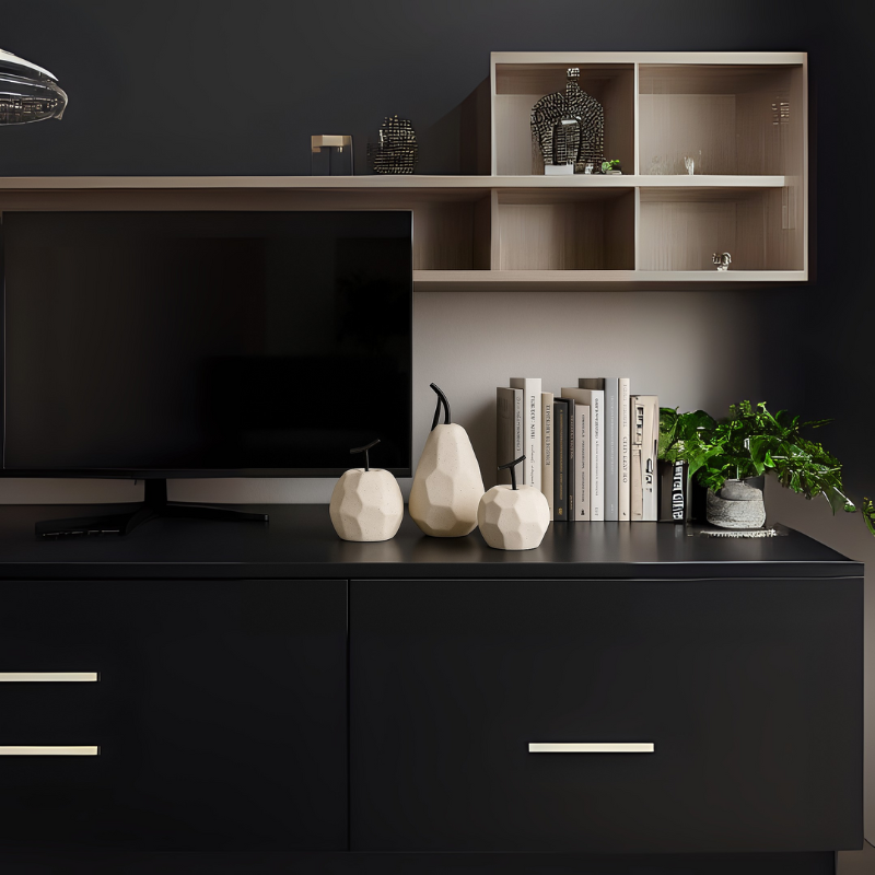 Stylish black TV console with geometric fruit sculptures, curated books, and greenery – modern decor by Milli Arts